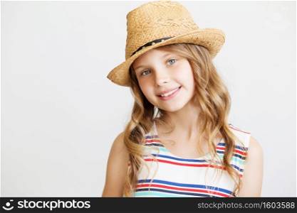 lovely little girl with straw hat against a white background