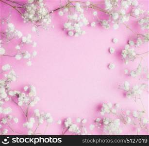 Lovely Little white Gypsophila flowers on pink background, pretty floral frame, top view, copy space, square