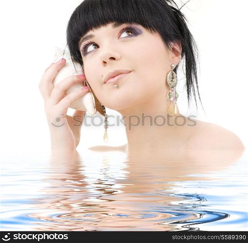 lovely oriental girl with shell in water