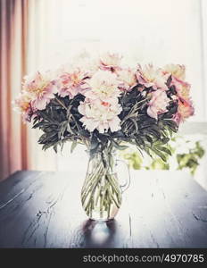 Lovely Peonies bunch in vase on table at window background, Still life