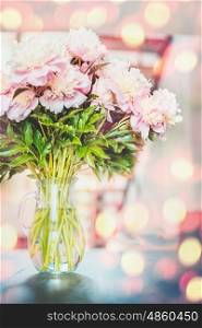 Lovely pink peonies flowers bunch in vase at sunshine bokeh background