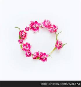 Lovely pink tulips flowers wreath on white desktop background. Top view. Flat lay. Layout. Design. Frame. Springtime composition. Mothers day