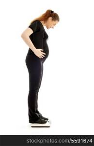 lovely pregnant lady weighing oneself over white background