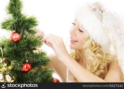 lovely santa helper girl decorating christmas tree