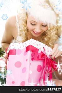 lovely santa helper girl with christmas gifts and snowflakes