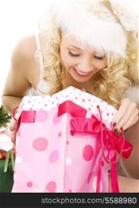 lovely santa helper girl with christmas gifts over white