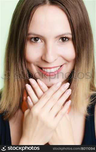 Lovely shy woman lauging. Smiling girl embarrassed covers her face with palms