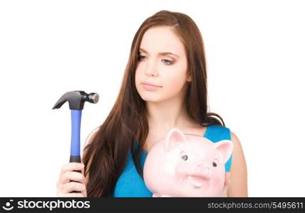 lovely teenage girl with piggy bank and hammer