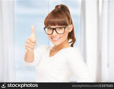 lovely teenage girl with thumbs up and glasses