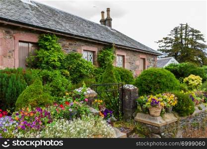 Lovely traditional village house and gardens in the village of Luss on Loch Lomond in Scotland, United Kingdom.