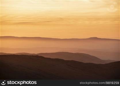 Lovely Winter landscape view from Red Screeds across misty layers of mountains Ill Bell, Stony Cove Pike and Tarn Crag