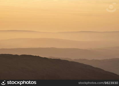 Lovely Winter landscape view from Red Screes across misty layers of mountains Ill Bell, Stony Cove Pike and Tarn Crag