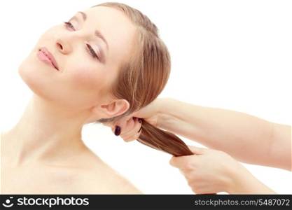 lovely woman face and female hand pulling her hair