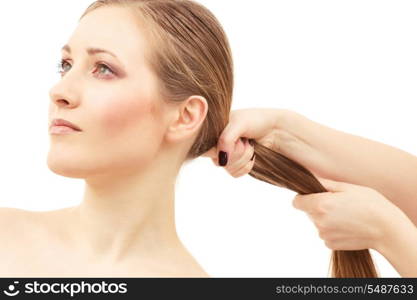 lovely woman face and female hand pulling her hair