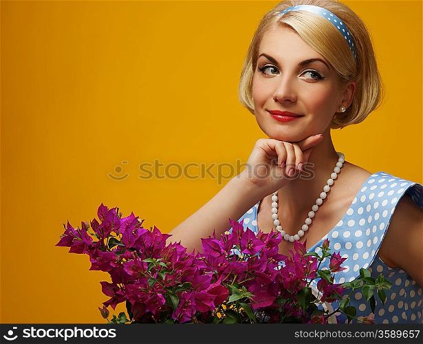 Lovely woman in a blue dress with a flowers