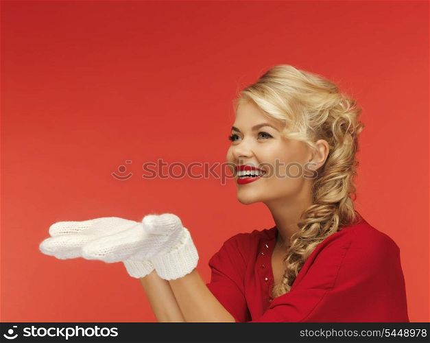 lovely woman in red dress and white mittens holding something on the palms