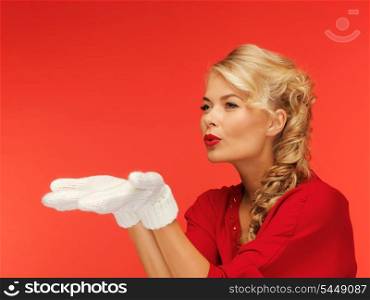lovely woman in red dress and white mittens holding something on the palms