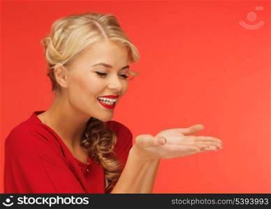 lovely woman in red dress showing something on the palms of her hands
