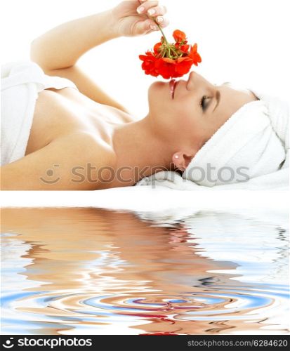 lovely woman in spa smelling red flower