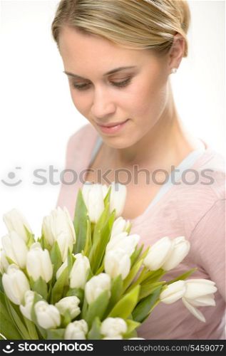 Lovely woman looking down white spring flowers bouquet of tulips