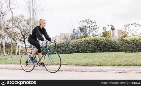 lovely woman riding bicycle park