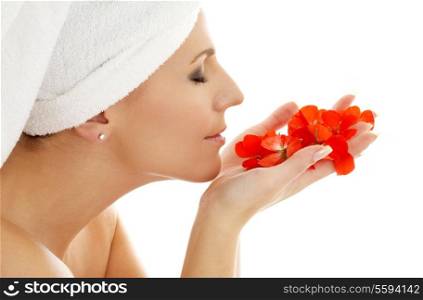 lovely woman smelling red flower petals