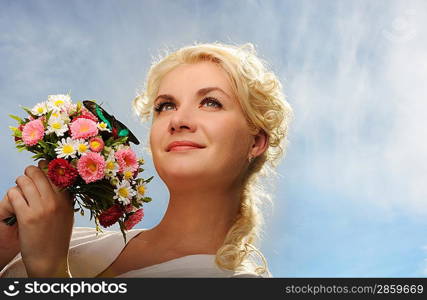 Lovely woman with a butterfly over blue sky