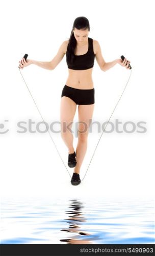 lovely woman with jump rope over white