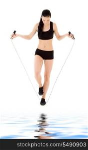 lovely woman with jump rope over white