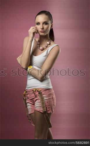 lovely woman with ponytail hair-style posing with casual clothes, suspenders and wrist watch