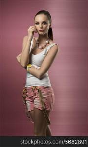 lovely woman with ponytail hair-style posing with casual clothes, suspenders and wrist watch