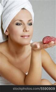 lovely woman with red candle in spa salon