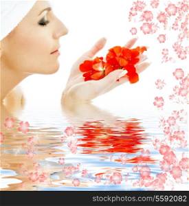lovely woman with red flower petals in water