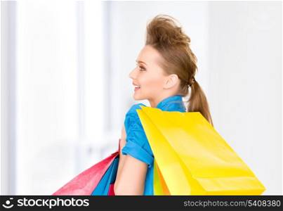 lovely woman with shopping bags in shop
