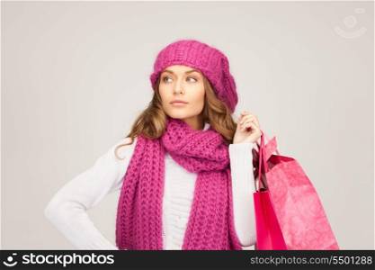 lovely woman with shopping bags over grey