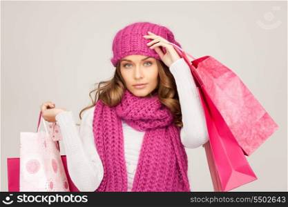lovely woman with shopping bags over grey