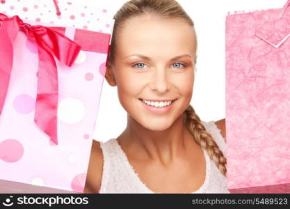 lovely woman with shopping bags over white