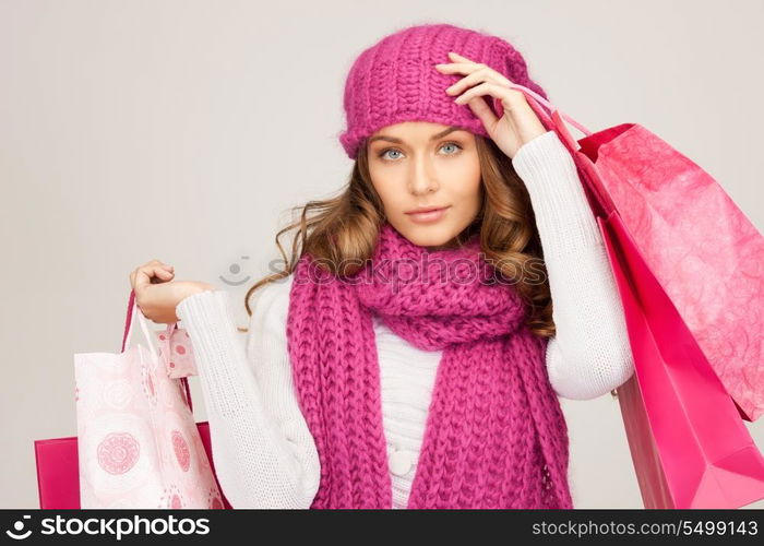 lovely woman with shopping bags over white