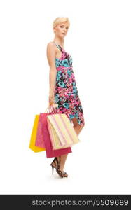 lovely woman with shopping bags over white