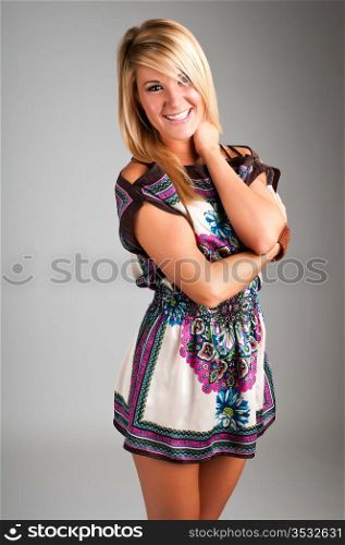 Lovely young blonde in a short tapestry dress
