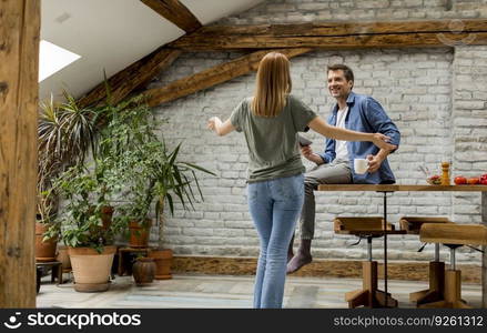 Lovely young couple having fun together at rustic kitchen