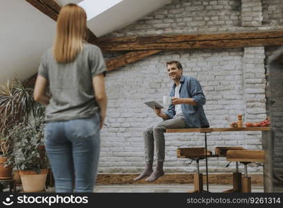 Lovely young couple having fun together at rustic kitchen