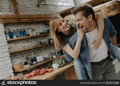 Lovely young couple having fun together at rustic kitchen