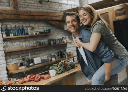 Lovely young couple having fun together at rustic kitchen