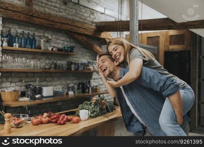 Lovely young couple having fun together at rustic kitchen