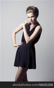 lovely young girl posing with charming fashion style, black dress, elegant hairdo and cute make-up.