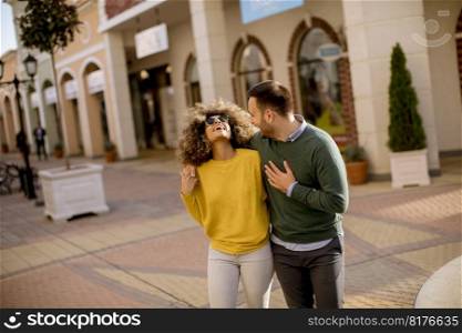 Lovely young multiethnic couple walking on the street