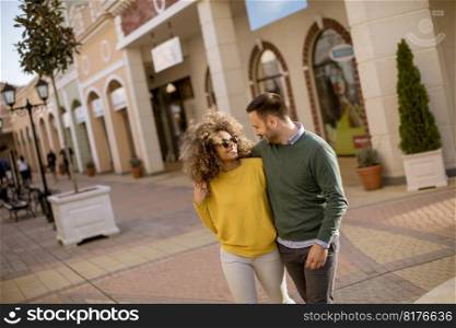 Lovely young multiethnic couple walking on the street