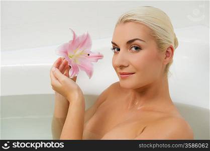 Lovely young woman relaxing in bathroom