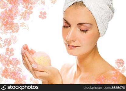 Lovely young woman with aroma bath ball in her hands.